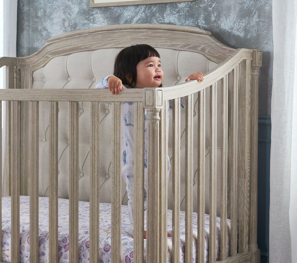 Baby crib with padded headboard sales